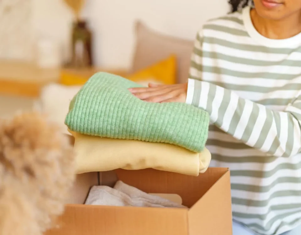 How to store clothes safely at Locked Self Storage Alloa, folding clean clothing into a storage box before placing items in secure indoor storage units.