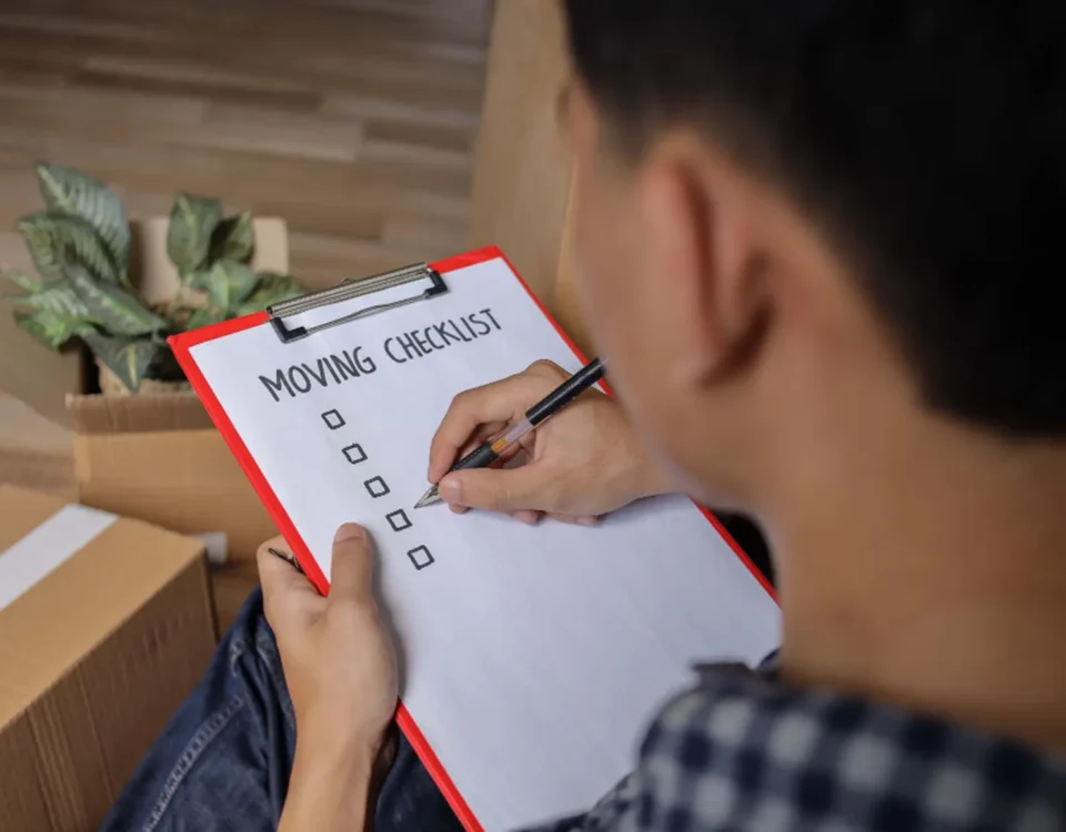 Over shoulder view of a man looking over his shoulder at a moving house checklist created by locked self storage alloa