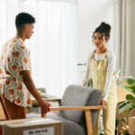 Couple preparing furniture for temporary furniture storage during a delayed house move before moving into their new home.