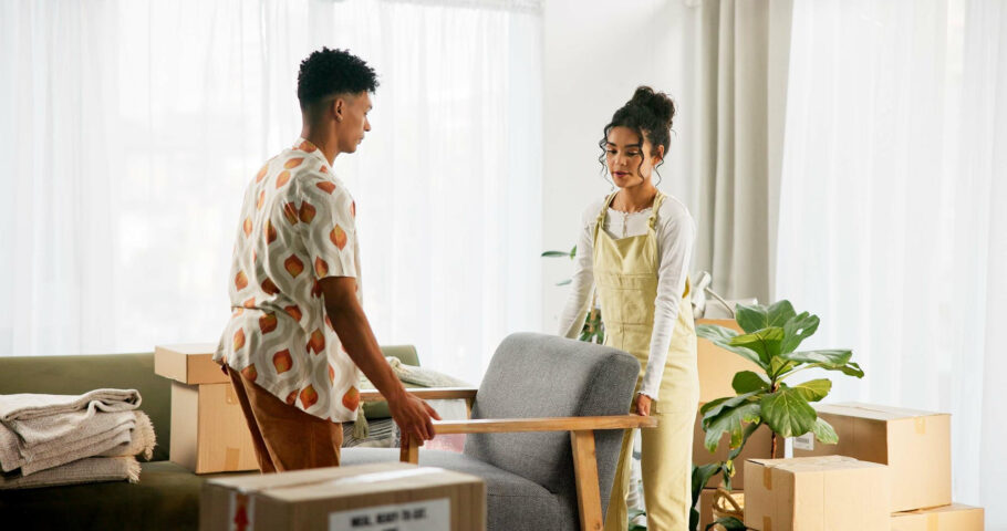 Couple preparing furniture for temporary furniture storage during a delayed house move before moving into their new home.